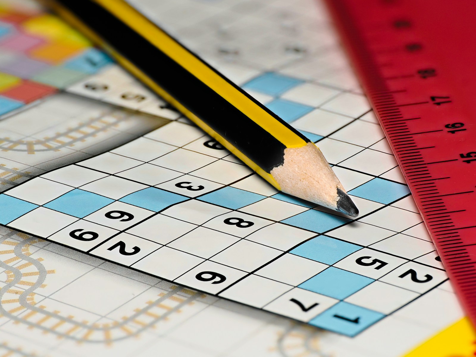A pencil sitting on top of a piece of paper next to a ruler